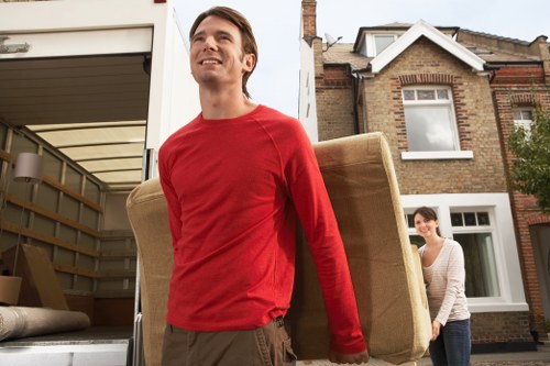 Loading household boxes into a removals van in central London